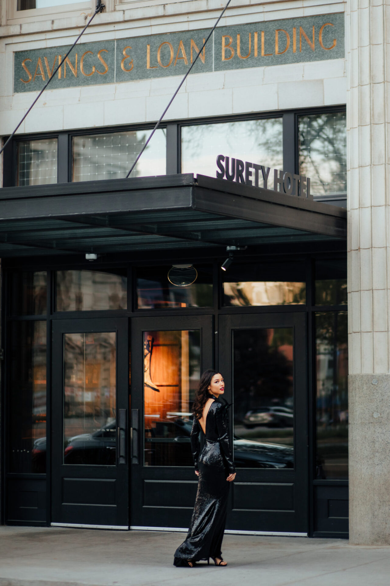 Woman walking into Surety Hotel in Des Moines, Iowa