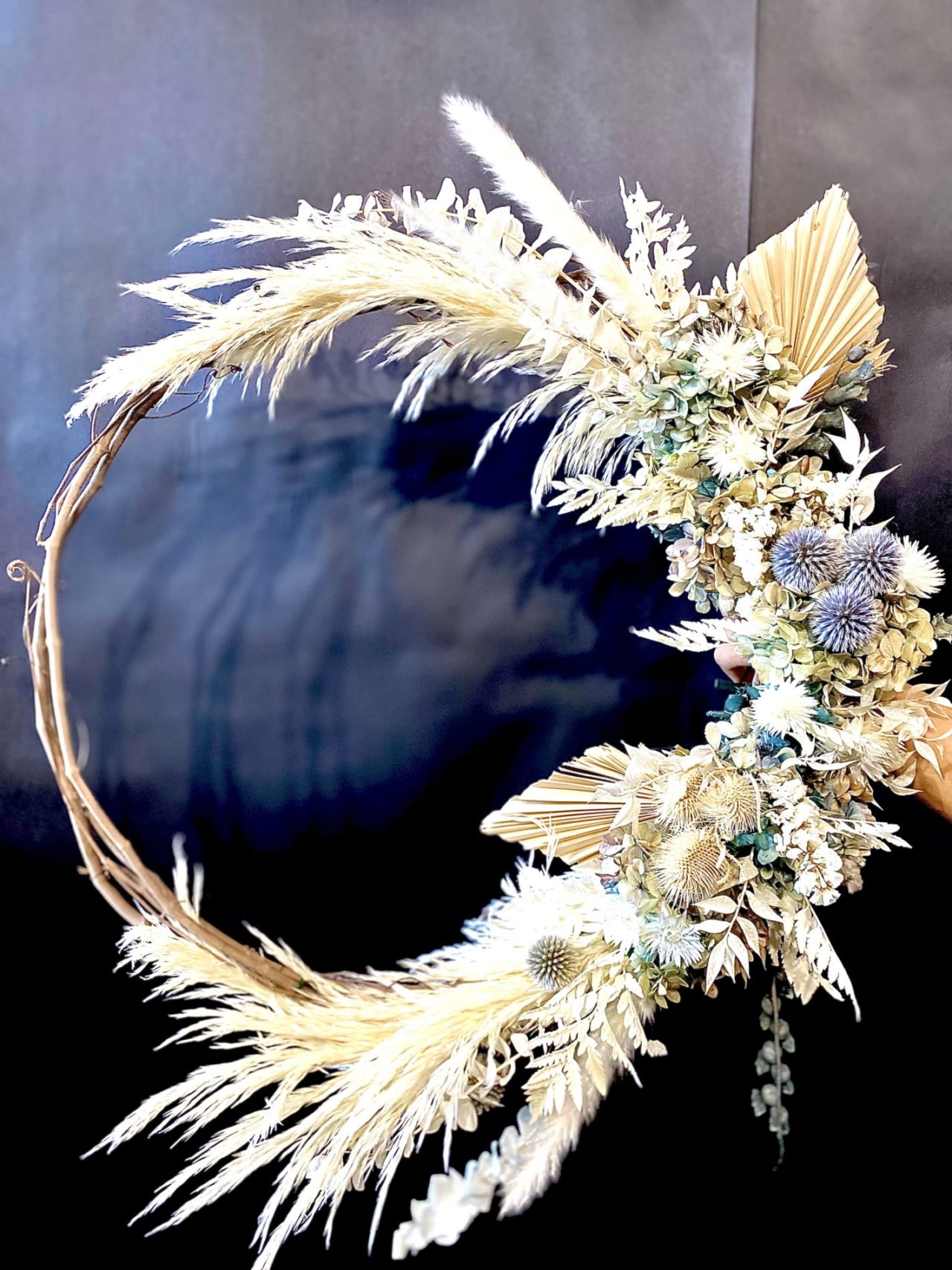 Elegant wreath on a brown table from Saley Nong of Petals and Moss during our Holiday workshop