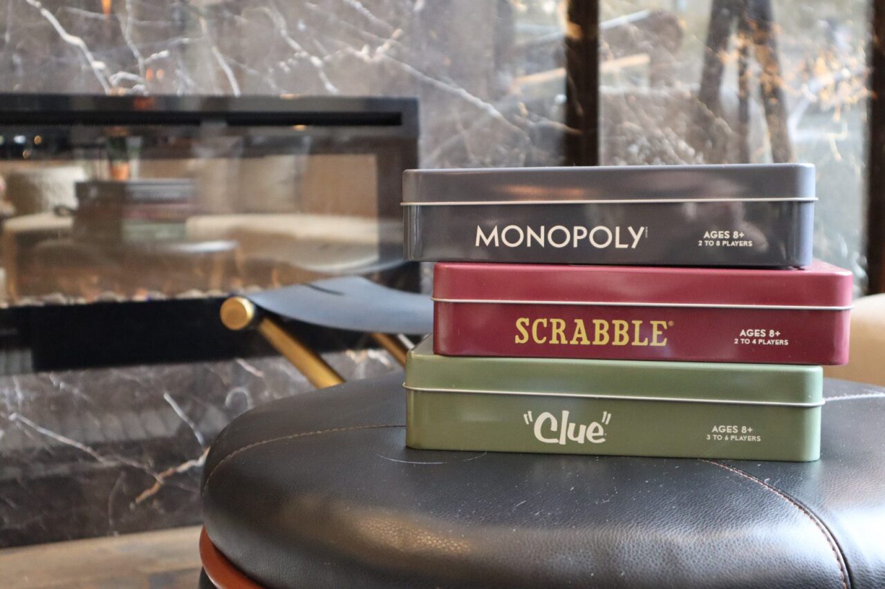 Metal tins of Monopoly, Scrabble, and Clue at our Des Moines, IA hotel