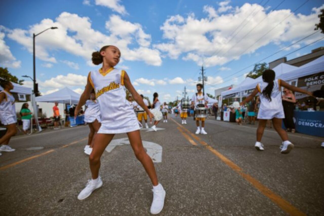 Young girl dancing in a parade at a downtown Des Moines event